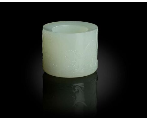  WHITE JADE 'MYTHICAL BEAST' THUMB RING QING DYNASTY, 18TH CENTURY 清 白玉雕瑞獸板指of cylindrical form, the exterior carved in low r