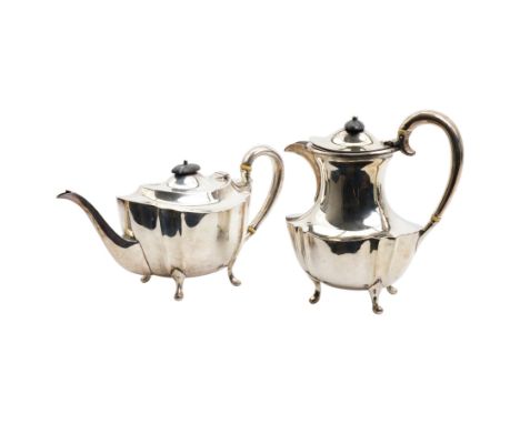 Silver oval teapot with ebonised lift, ivory insulators, loop handle and raised on four shaped supports and matching hot wate