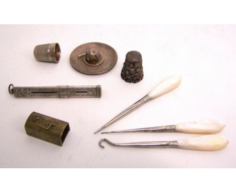 A collection of miniature Silver items including thimbles, button hooks, sombrero hat etc