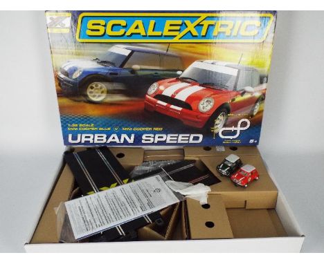 Scalextric - A boxed set # C1324 with 2 x Mini Coopers. The set appears in Good condition but the two Mini cars in it are not