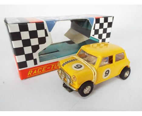 Scalextric - A vintage 1970s C-7 Mini Cooper in yellow in a reproduction box. The car appears in Very Good condition with lig