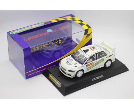 Scalextric - A boxed Mitsubishi Lancer Evo 7 WRC Collectors Club 5005 edition # C2682. The car appears Mint in a Very Good pe