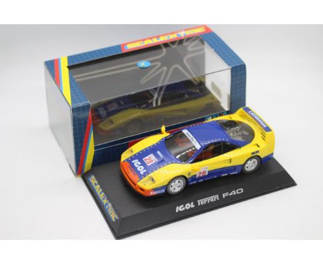 Scalextric - A boxed Ferrari F40 in IGOL racing livery # C2036. The car appears Mint in a Very Good display case with light s