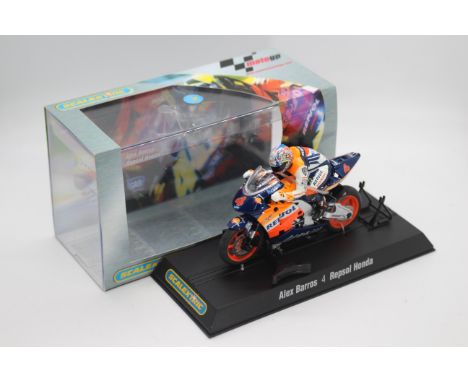 Scalextric - A boxed 2004 Moto GP Repsol Honda ridden by Alex Barros # C6004 The model appears Mint in a Very Good perspex di