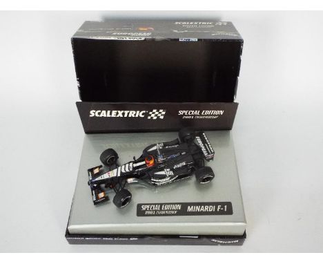 Scalextric - a boxed Minardi F1 special edition 2001 Championship car # 6194. The car appears Mint in a Very Good presentatio