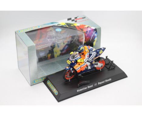 Scalextric - A boxed 2004 Moto GP Repsol Honda ridden by Valentino Rossi # C6000 The model appears Mint in a Very Good perspe
