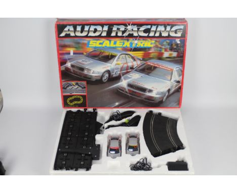 Scalextric - A boxed # C.1015P Audi Racing set with two Audi A4 Touring cars. The set shows signs of age and play use and is 