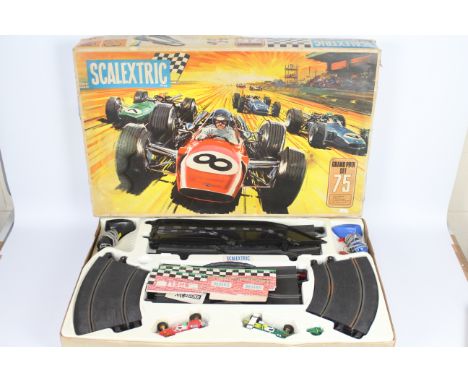 Scalextric - A vintage boxed Scalextric Grand Prix 75 set with a C/8 Lotus Indianapolis and a C/9 Ferrari GP car. The set is 