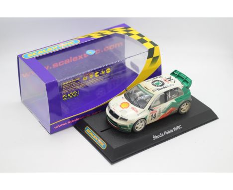 Scalextric - A boxed Skoda Fabia Works WRC 4x4 with working lights # C2487B. The model appears Mint in a Very Good perspex di