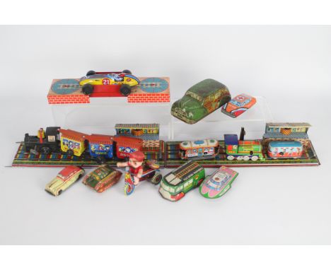 Wells Brimtoy, MTU,Other -  A collection of vintage tinplate transport related toys. Lot includes a Japanese made Boy on Tric