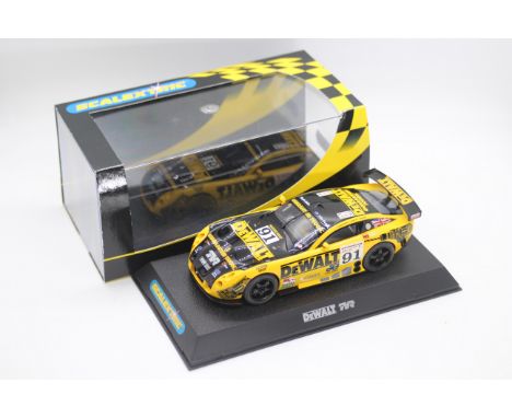 Scalextric - A boxed TVR Tuscan 400R in DeWalt racing livery # C2453. The car appears Mint  in a Very Good perspex display ca