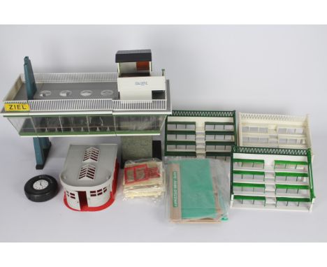 Herpa, Scalextric, Gilbert, Other - A collection of Scalextric and Herpa trackside buildings. Lot includes a Scalextric Spect