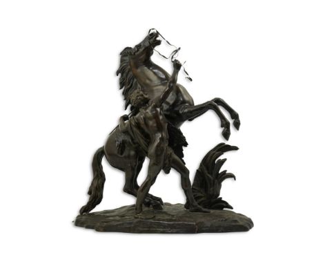 After Guillaume Coustou (1677-1746), a bronze Marli horse group with rearing horse and groom, on naturalistic signed base, 53