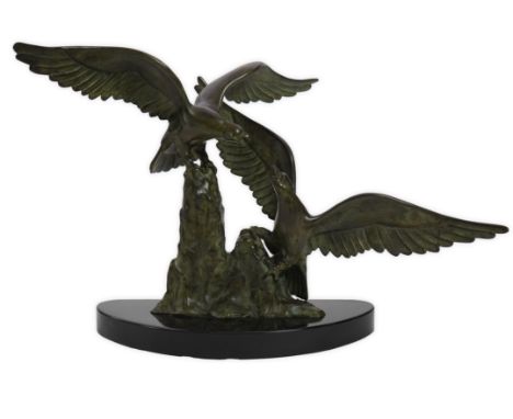 Badini, a French Art Deco bronze group of eagles in combat, signed, stamped ‘BRONZE’ and ‘BADINI’, on black marble base, 72cm