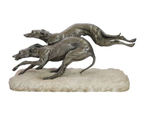 Thomas Cartier (1879-1943), a French Art Deco silvered bronze group of two running hounds, upon a naturalistic rock base, sig