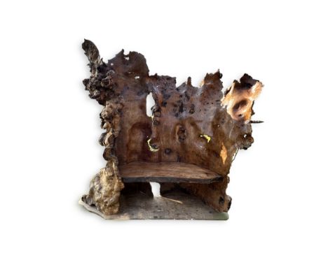 A rustic elm seat, made from the wood of The Chequers Elm, Horley, by Colin Ford, in 2008, 200cm wide, 80cm deep, 195cm high 
