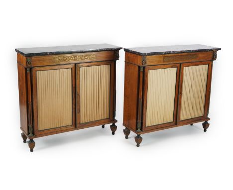 A pair of Regency brass ormolu mounted rosewood side cabinets with variegated red marble tops, the frieze set with lion mask 