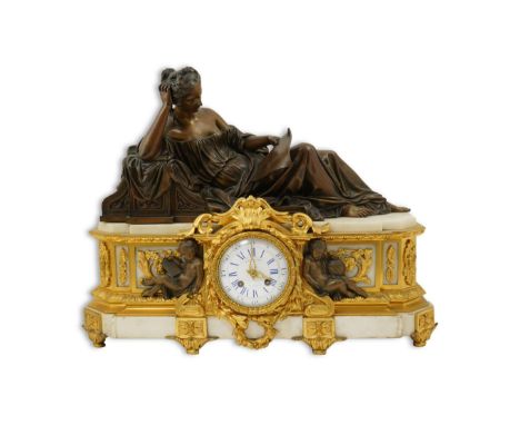 Raingo Freres, Paris, a Louis XV style bronze ormolu and white marble mantel timepiece surmounted with a reclining muse readi