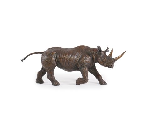 § § James Osborne (English, 1940-1992), a bronze model of a charging rhinoceros, signed in the bronze and numbered 5/10, 57cm