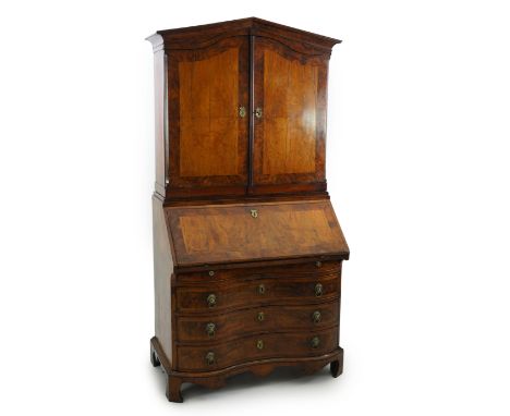 A late 18th century South German walnut bureau bookcase of architectural form, with two doors enclosing shelves and short dra