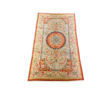 A Savonnerie carpet, with central rosette on a field of scrolling shell and foliate motifs, 372 x 220cm PLEASE NOTE:- Prospec