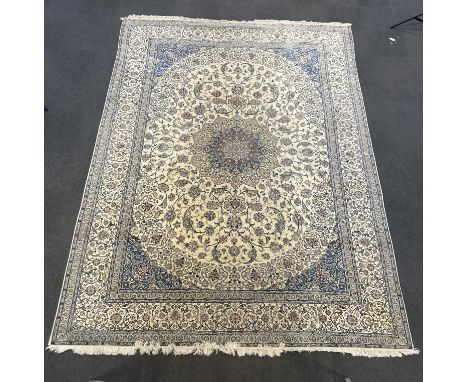 A Tabriz cream ground carpet woven with scrolling flowers and leaves, in blue and red, 470 x 317cm PLEASE NOTE:- Prospective 