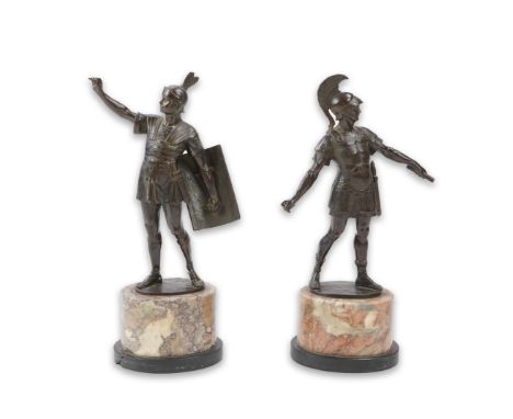 Gotthilf Jaeger (German, 1871-1933), a pair of bronze figures of Roman soldiers, one holding a baton, the other with arm outs