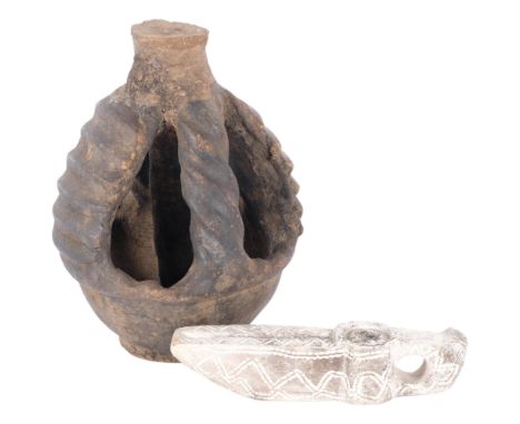 A Yoruba pottery lamp. H - 22cm, and a soapstone lamp. H - 18cm. (2). 