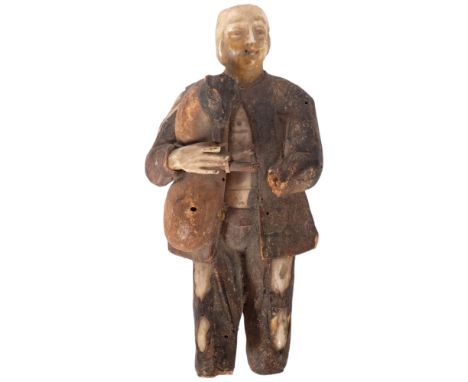 An antique Folk Art carved wood and bone figure of a man playing the bagpipes. H - 15cm.Missing left hand and both feet, top 