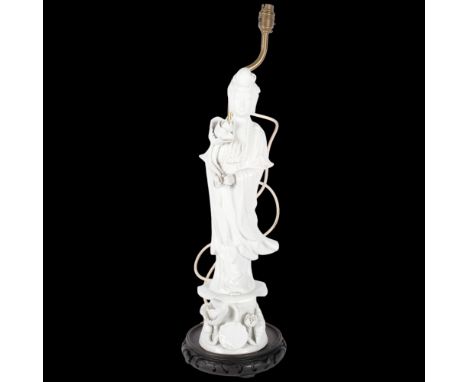 A blanc de chine porcelain figure lamp, on carved and pierced wood plinth, H68cm overall (1 finger A/F) 
