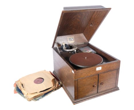 'HMV' - model 109 gramophone in oak case. With associated spare needle tins by Columbia and Dulcetto. And a quantity of 78rpm