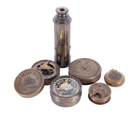 A reproduction brass telescope, compass, perpetual calendar, 7.5cm across, etc 