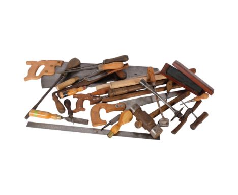 A box of carpentry tools, and a saw 