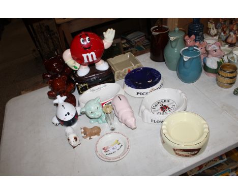 A quantity of advertising ash trays, Poole pottery piggy bank, M7M figure etc.