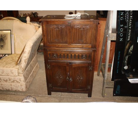 A linen fold decorated drinks cabinet 