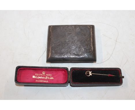 A silver cigarette case approx. 63gms and a yellow metal mounted stick pin