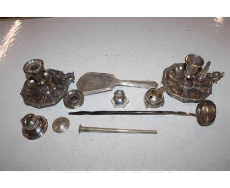 A silver inkwell; a white metal toddy ladle; section of a silver backed dressing table hand mirror; a pair of chamber sticks;