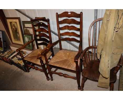 An oak and rush seated ladder back chair and another similar