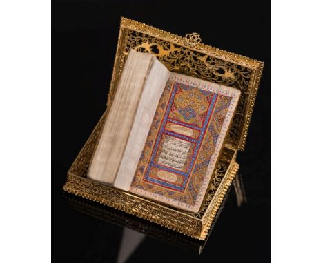KORAN : illuminated manuscript in filigree gold box - leather backed floral covers, 89 x 57 mm,  A.H. 1246 [1830 A.D].
* The 