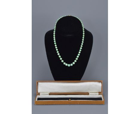 A Chinese vintage graduated jade bead necklace with 9ct gold clasp. With box. Bead size 4mm - 8mm. Length approx. 40cm