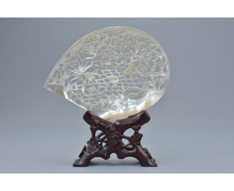 A Chinese vintage mother-of-pearl shell with pierced decoration depicting birds in tree on wooden stand. 20cm height includin