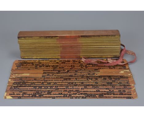 A 19th century Burmese palm leaf manuscript with wooden boards and biding ribbon together with nine assorted 19th century Bur