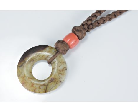 Chinese Polished Jade Disc, 4cms diameter, possibly Ming, on a Later Plaited string