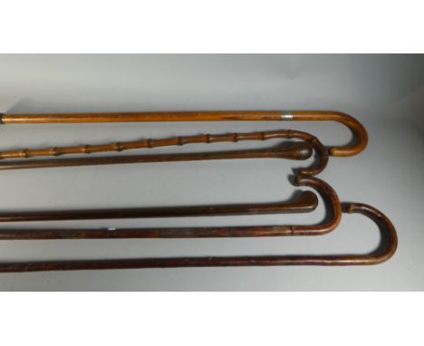 A Collection of Six Vintage Wooden Walking Sticks and Canes