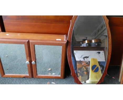 A Pine Bathroom Cabinet with Mirrored Doors and Vintage Oval Wall Mirror