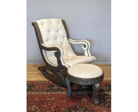 A substantial cream leather rocking chair, with middle eastern inspired metal work decoration, possibly Moroccan, button back