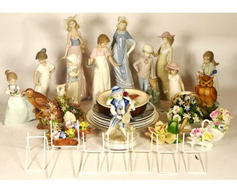 A collection of ten Nao figurines, together with collector plates and other cabinet pieces. 