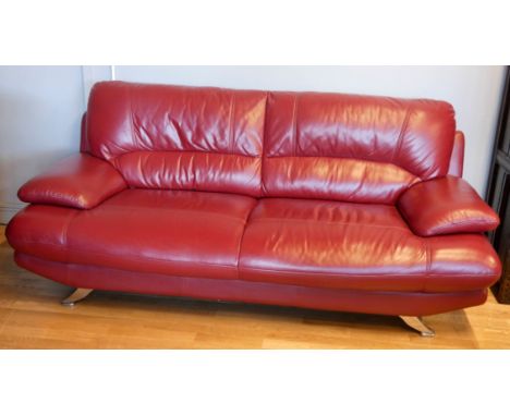 A red leather Italian style sofa, on chromed legs, 205 x 90 x 95cm