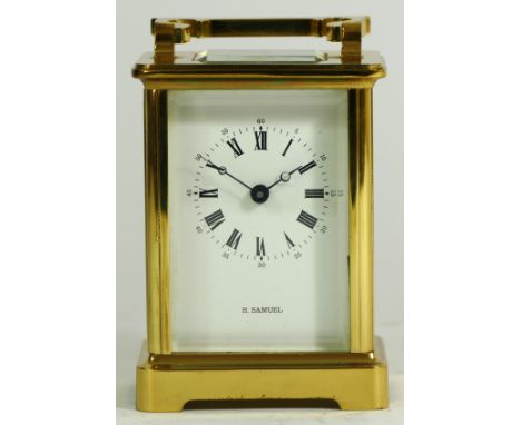 An English 8 day brass carriage clock, having enamelled dial with Roman numerals, the jewelled movement stamped Made In Engla