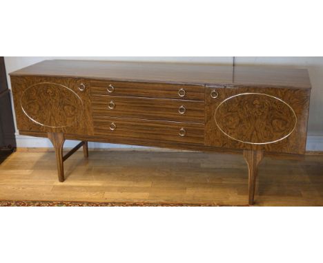 A unbranded 1960's sideboard, veneered front and top, with gild decorations, three graduated drawers flanked by hinged doors,